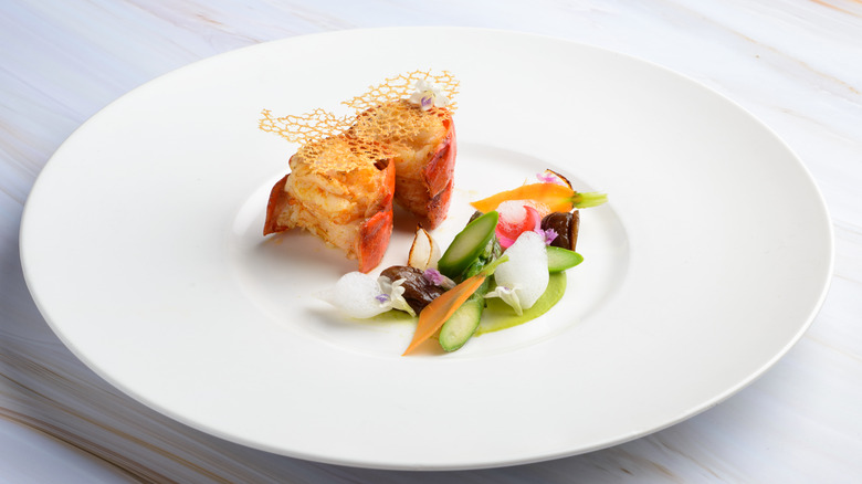 Plate of food with two pieces of lobster