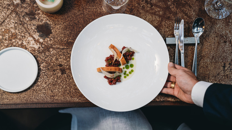 Waiter plating food 