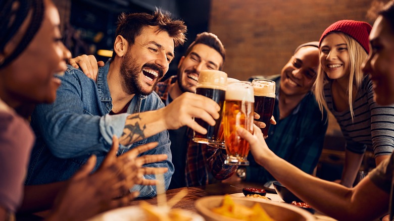 Friends clinking glasses at a bar