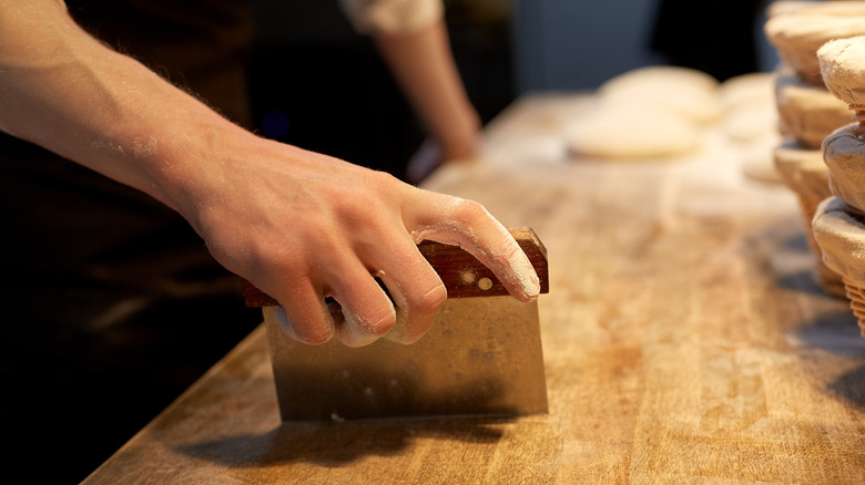 hand using a bench scraper