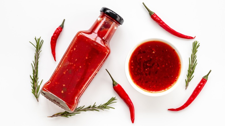 Hot sauce bottle and chiles