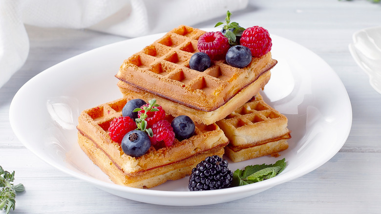 Belgian waflfes with blueberry and rasperry toppings