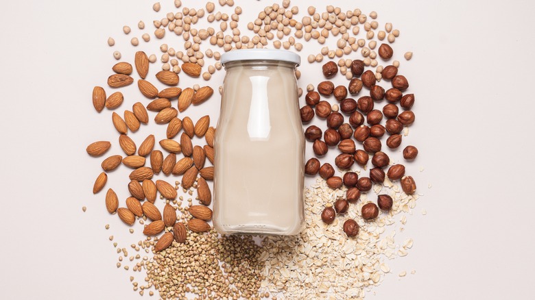 Bottle of liquid surrounded by nuts