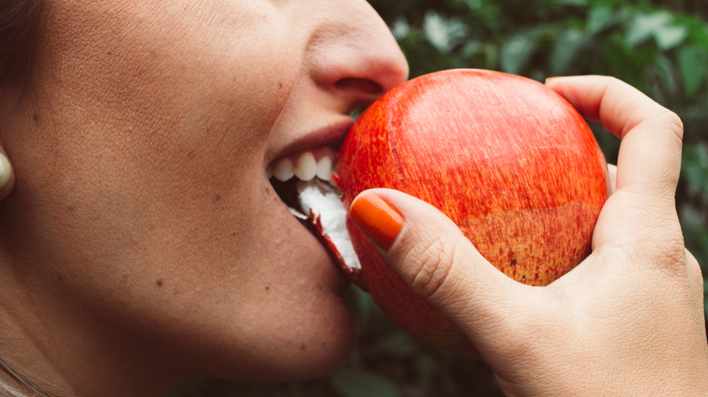 Woman biting into apple