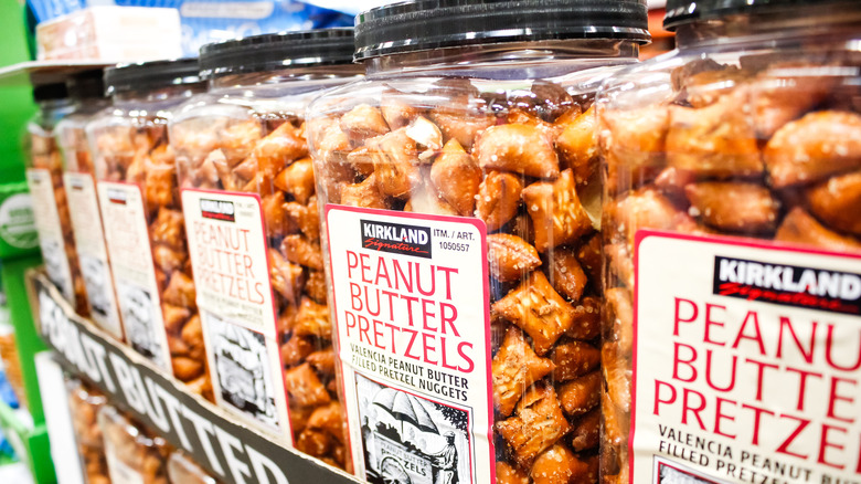 Jars of peanut butter pretzels on a shelf