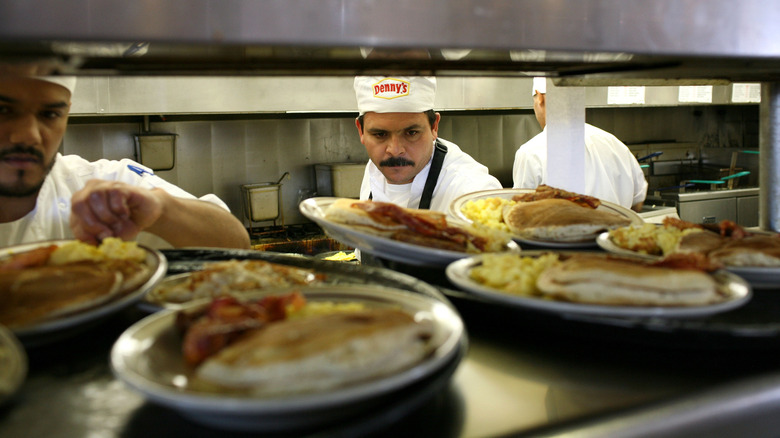 Short cooks serving plates at Denny's