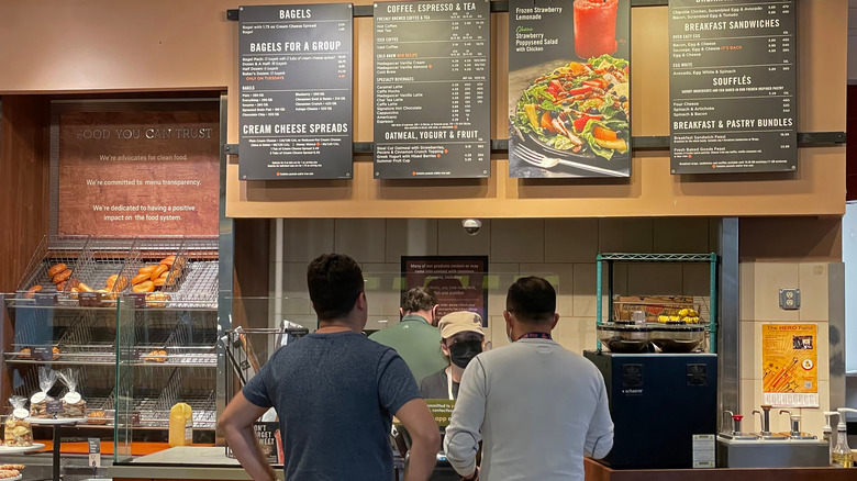 Two customers stand in line at Panera Bread