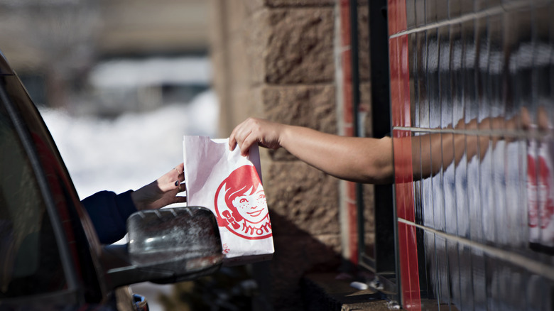 receiving a drive-through order at Wendy's
