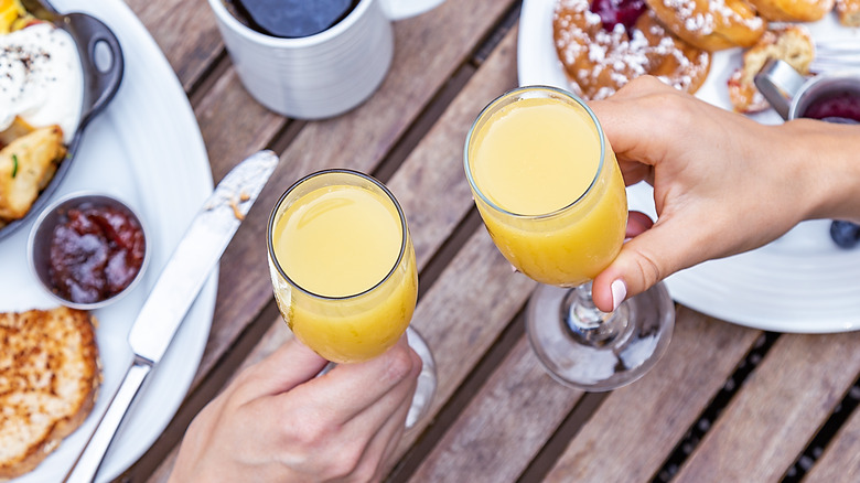People drinking mimosas at brunch