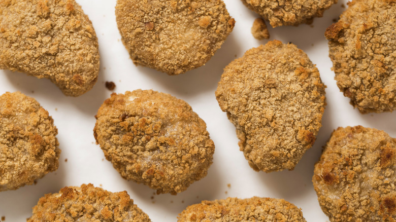 Chicken nuggets against a white background