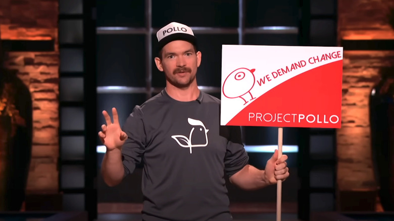 Lucas Bradbury holds Project Pollo sign on Shark Tank
