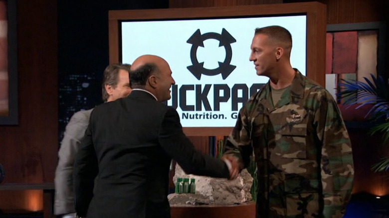 Dyer shaking hands with Kevin O'Leary and Robert Herjavec on "Shark Tank"