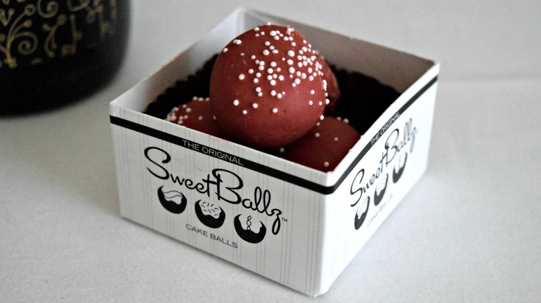 Small, open box of chocolate Sweet Ballz in company logo box