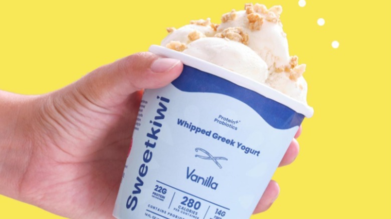 hand holding Sweetkiwi whipped Greek yogurt