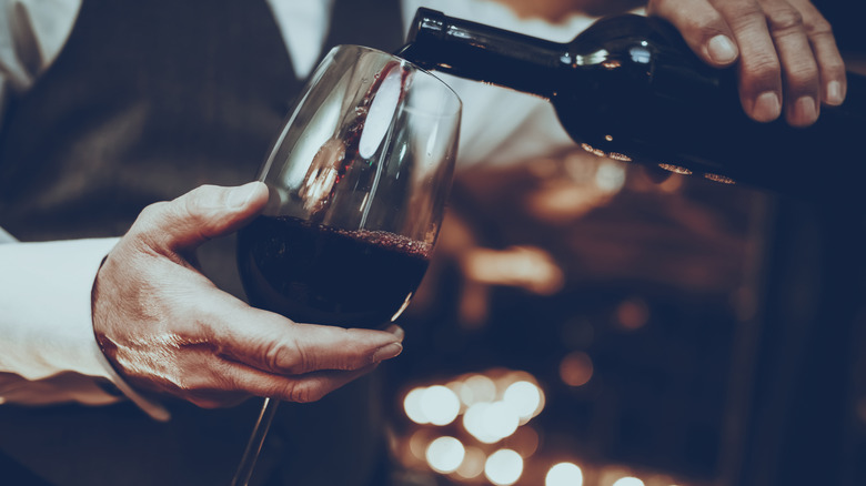 Sommelier pours red wine