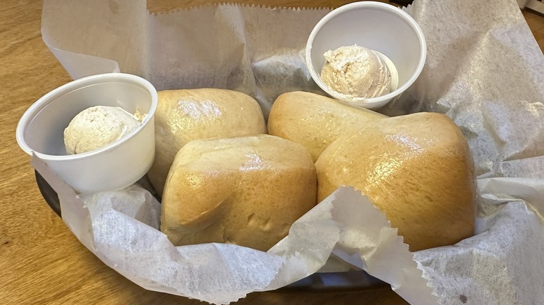 Texas Roadhouse fresh rolls with honey cinnamon butter in basket