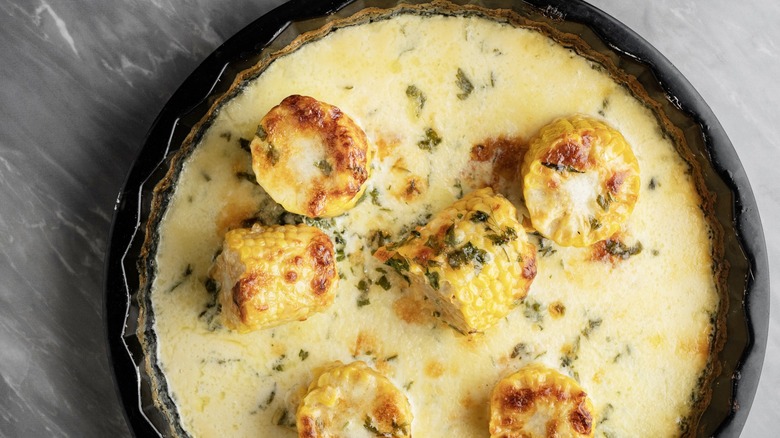 corn on the cob in cream sauce in dish