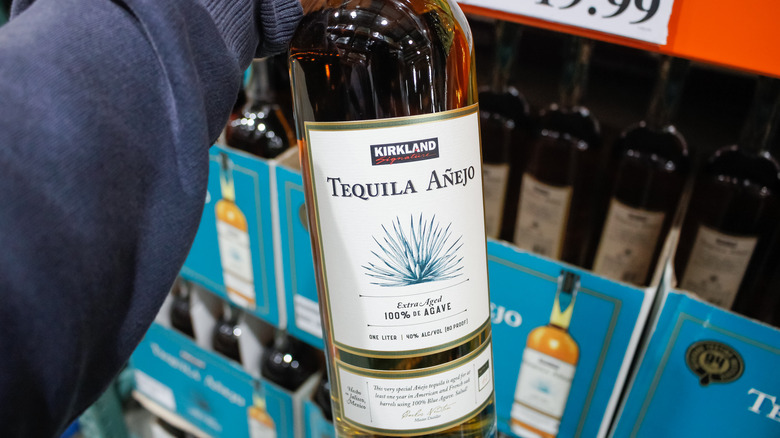 Person holding Tequila Anejo