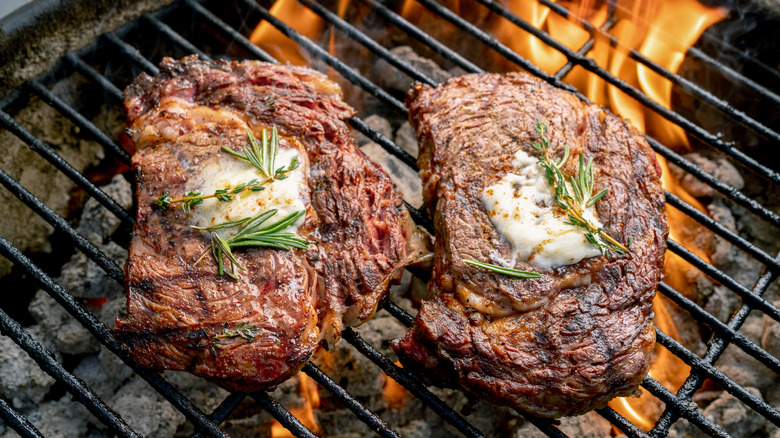 Two steaks on a charcoal grill