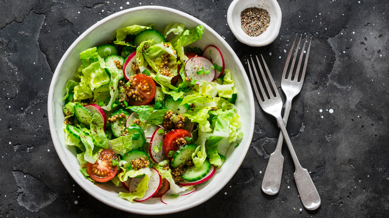 Mixed green salad on dark background