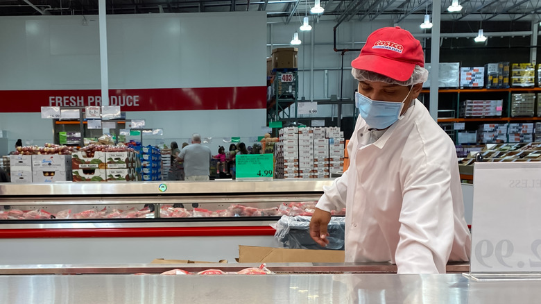 Costco employee stocking cooler