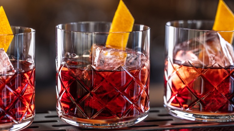 Three Negronis with ice and garnish