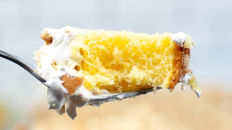 bite of pudding poke cake on fork
