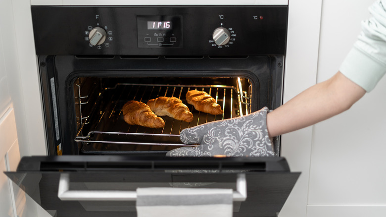 placing croissants in an oven