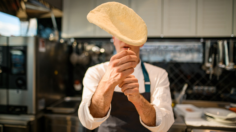 Pizza dough thrown in air
