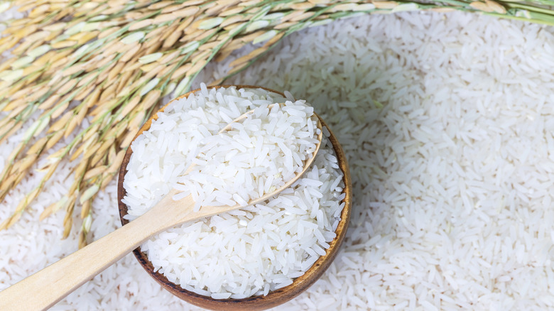 Rice in a bowl sitting on a bed or rice. 