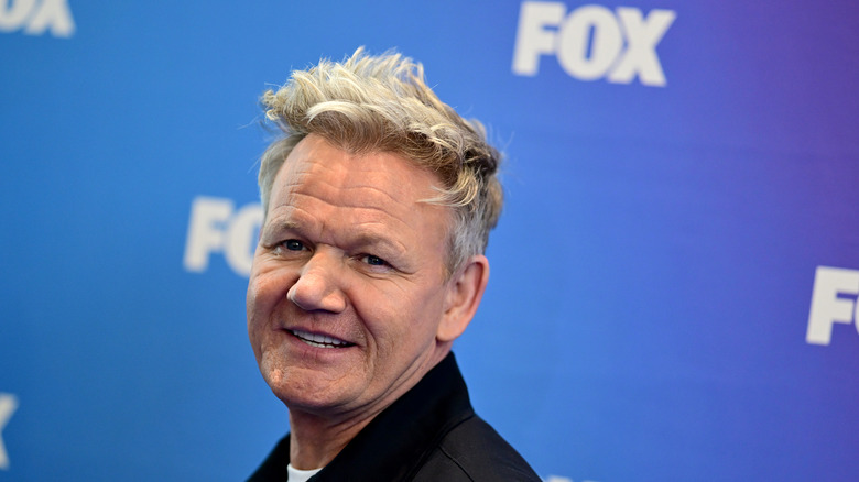 Gordon Ramsay smiling in front of a FOX network backdrop