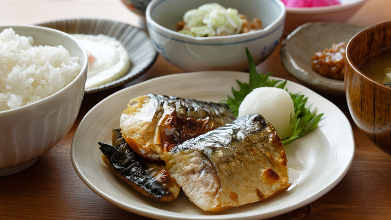 Traditional Japanese breakfast comprising rice, miso soup, fish and side dishes.