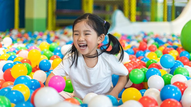 Child playing in ball pit