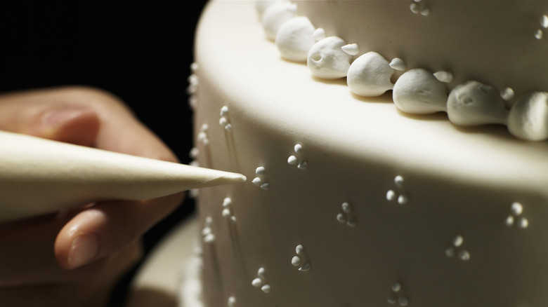 Person decorating cake