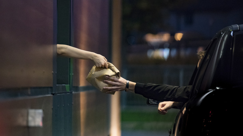 hand grabbing take out at drive thru 