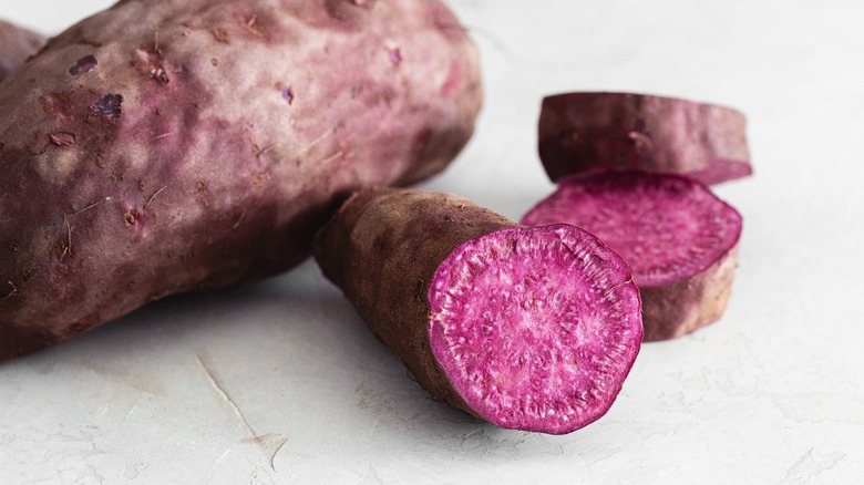 whole purple sweet potato with slices