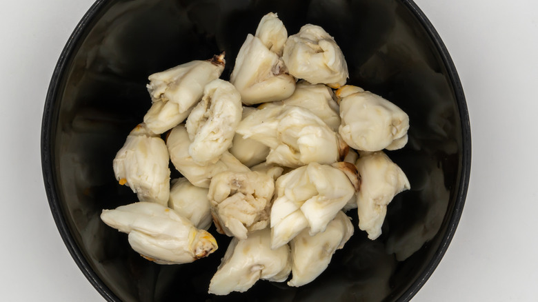 a black bowl of premium jumbo lump blue crab meat