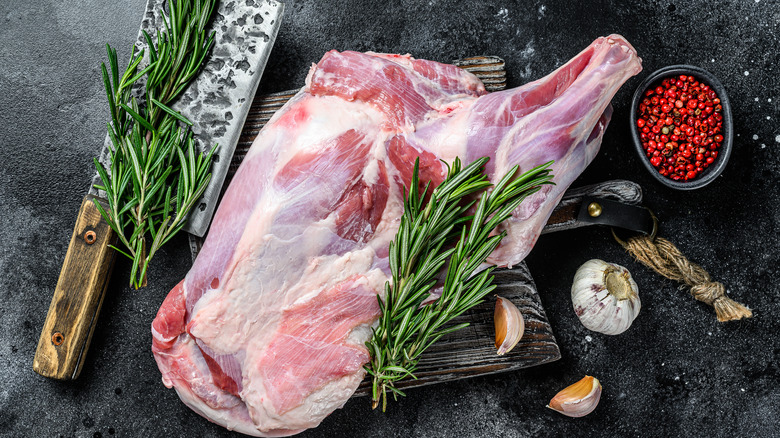 Raw lamb shoulder with rosemary herbs