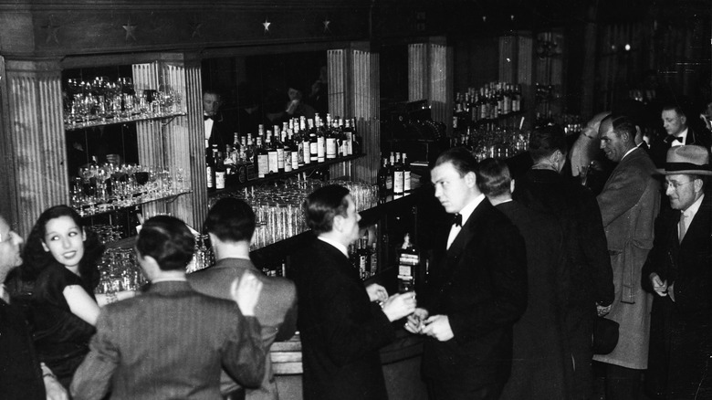 Patrons gather at a bar