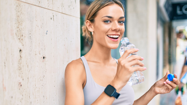 woman drinking bottled water