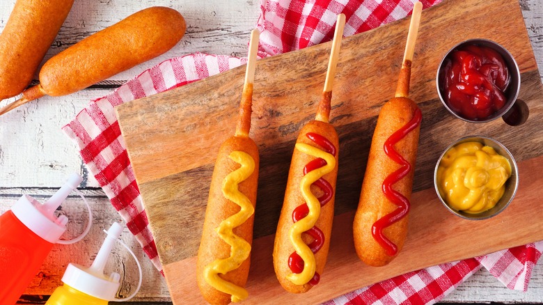 Deep-fried corn dogs with mustard and ketchup 