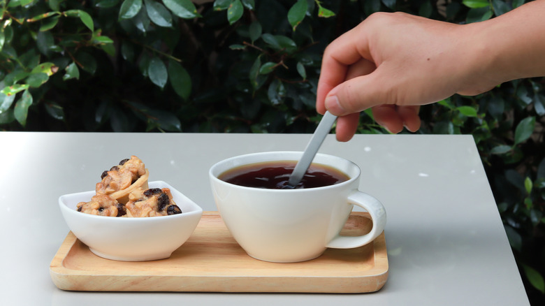 Hand stirring coffee 