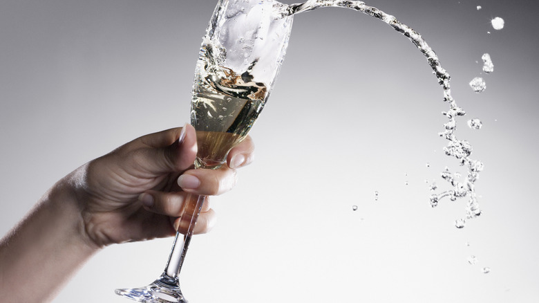 Champagne coming out of glass
