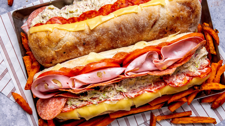 Grinder sandwich with deli meat - toppings served in a fresh baguette