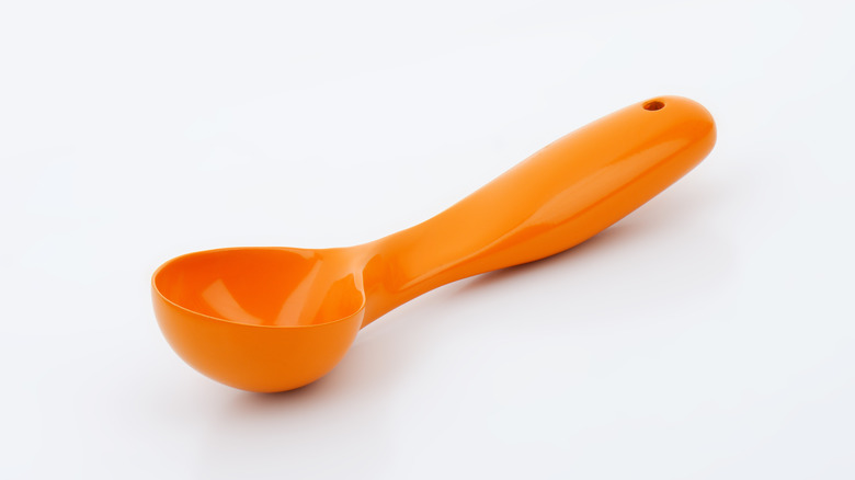 Metal scooper with chocolate ice cream