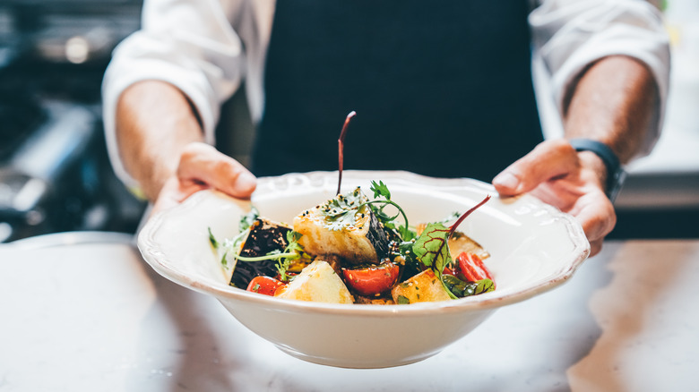 chef holding vegetable dish