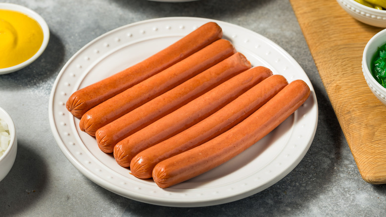 Six plain hot dogs on white plate