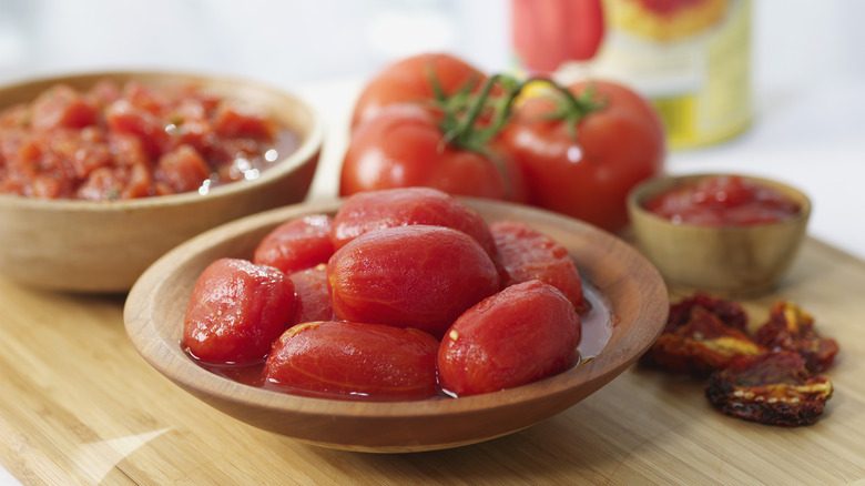 Whole canned tomatoes on dish