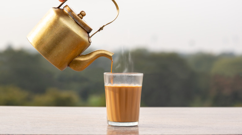 gold teapot pouring chai