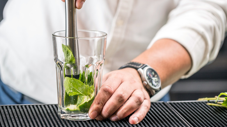muddling mint in glass